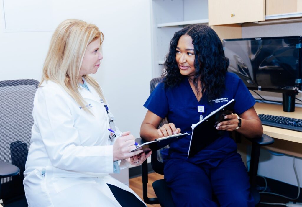 Two clinicians at UT Southwestern reviewing paperwork