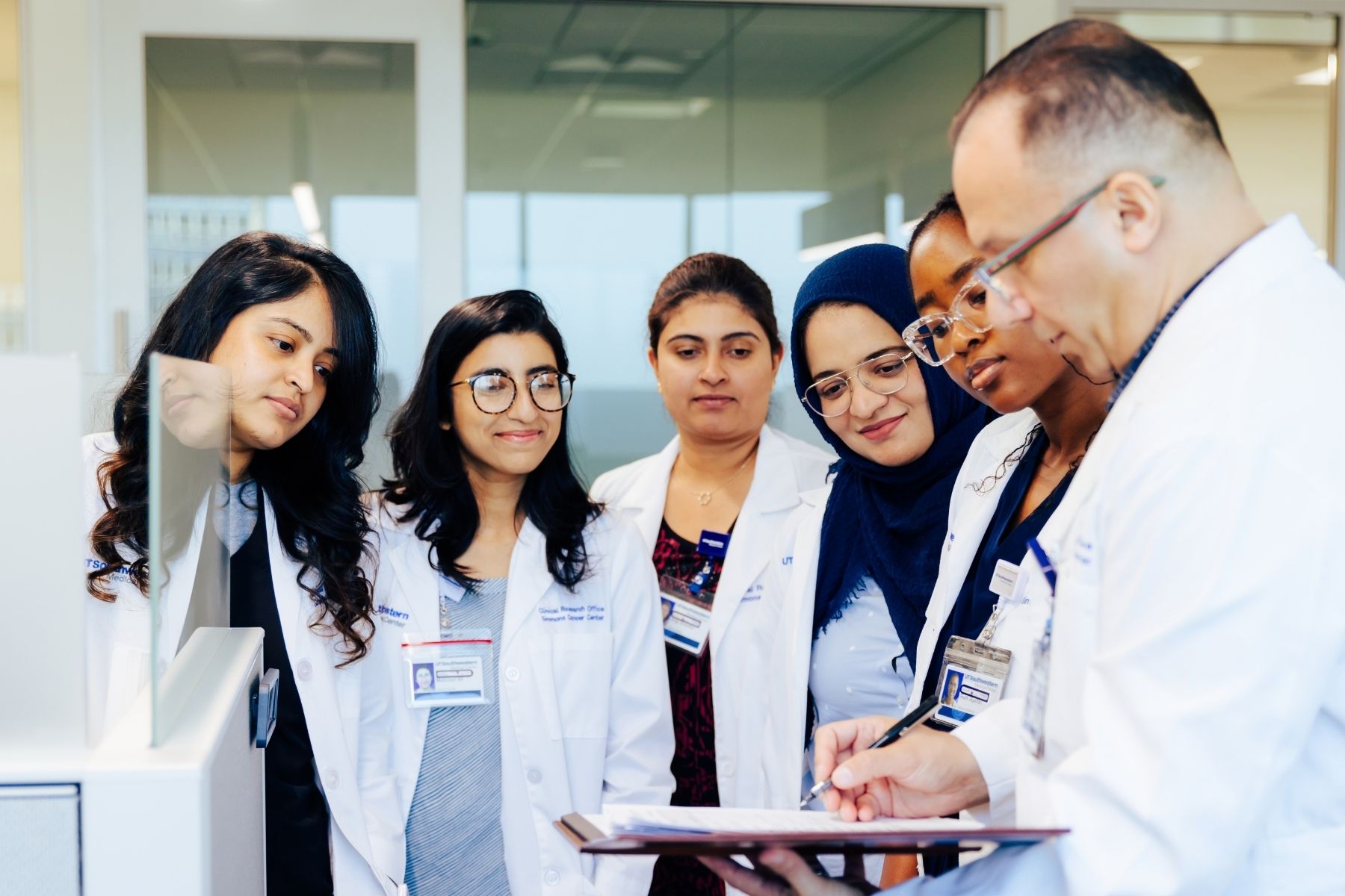 Six clinicians at UT Southwestern reviewing paperwork