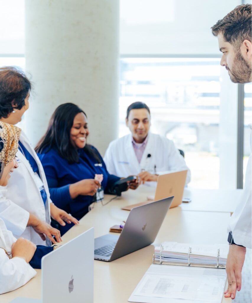 Four clinicians at UT Southwestern Medical Center reviewing paperwork